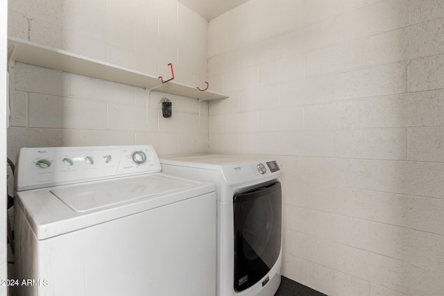 clothes washing area with washing machine and clothes dryer