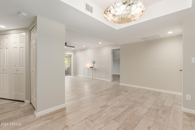 spare room with ceiling fan and light wood-type flooring