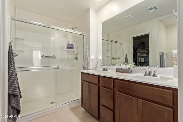 1617 W Pima Ct, Coolidge, AZ 85128 - bathroom featuring tile patterned floors, a shower stall, double vanity, and a spacious closet