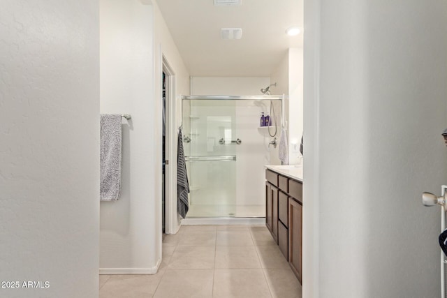 1617 W Pima Ct, Coolidge, AZ 85128 - bathroom featuring a shower stall, tile patterned floors, vanity, and a textured wall