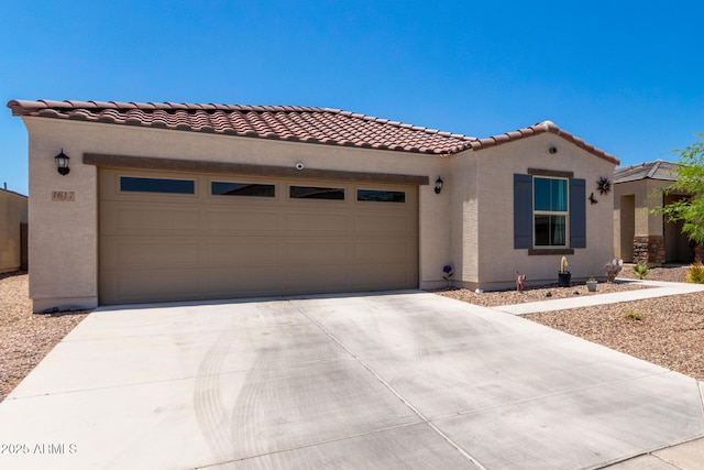 1617 W Pima Ct, Coolidge, AZ 85128 - mediterranean / spanish home featuring an attached garage, driveway, stucco siding, and a tiled roof