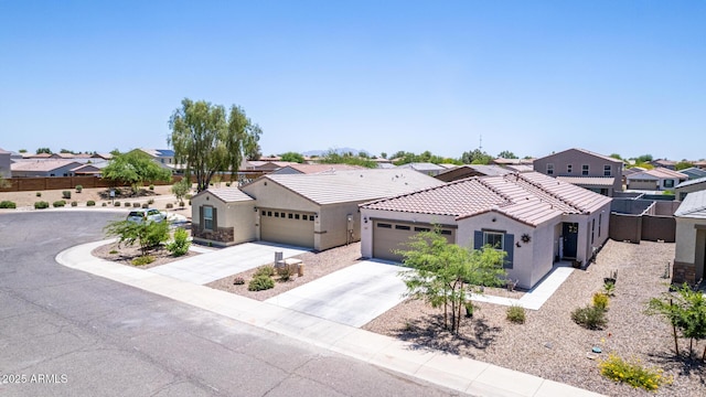 1617 W Pima Ct, Coolidge, AZ 85128 - mediterranean / spanish-style home featuring a residential view, stucco siding, concrete driveway, an attached garage, and a tiled roof