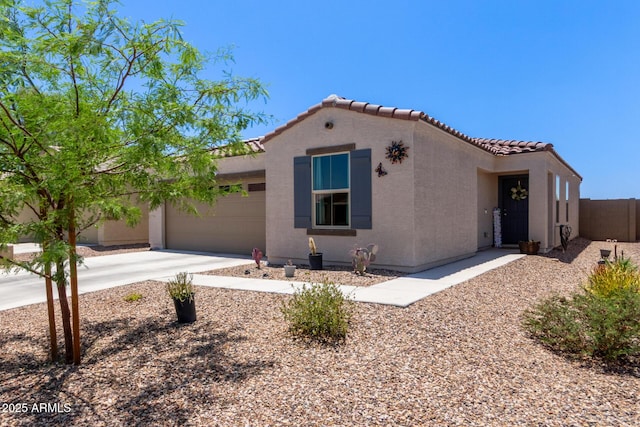 1617 W Pima Ct, Coolidge, AZ 85128 - mediterranean / spanish-style home with a garage, stucco siding, concrete driveway, and a tiled roof