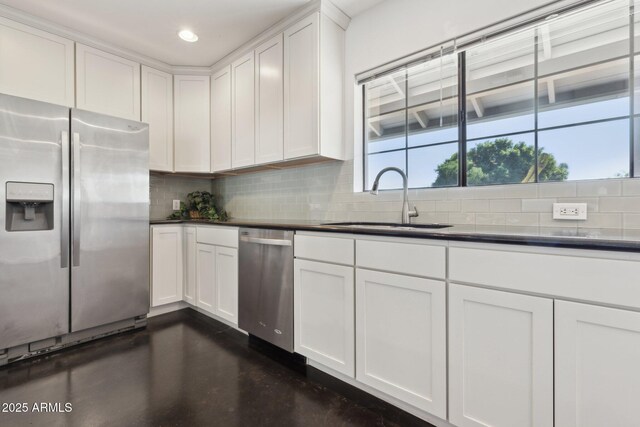 2740 N 21st Dr, Phoenix, AZ 85009 - kitchen featuring appliances with stainless steel finishes, decorative backsplash, a sink, and dark countertops