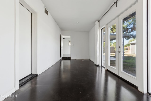 2740 N 21st Dr, Phoenix, AZ 85009 - hall with concrete flooring, french doors, baseboards, and visible vents