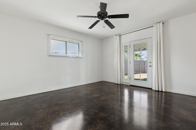 2740 N 21st Dr, Phoenix, AZ 85009 - spare room featuring concrete flooring, a wealth of natural light, ceiling fan, and baseboards