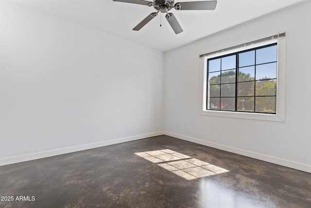 2740 N 21st Dr, Phoenix, AZ 85009 - spare room featuring concrete floors, baseboards, and a ceiling fan