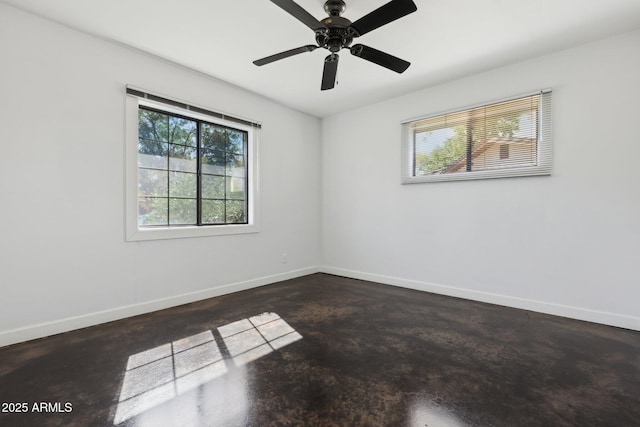 2740 N 21st Dr, Phoenix, AZ 85009 - unfurnished room featuring concrete flooring, baseboards, and a healthy amount of sunlight
