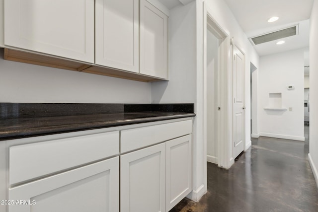 2740 N 21st Dr, Phoenix, AZ 85009 - hallway with recessed lighting, visible vents, finished concrete flooring, and baseboards