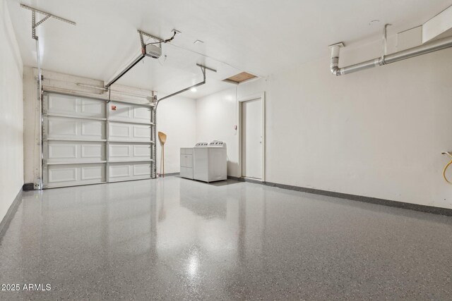 2740 N 21st Dr, Phoenix, AZ 85009 - garage featuring separate washer and dryer, baseboards, and a garage door opener