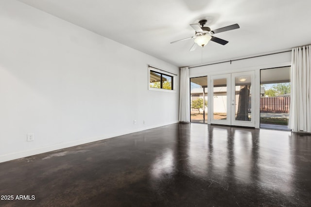 2740 N 21st Dr, Phoenix, AZ 85009 - spare room featuring french doors, baseboards, a ceiling fan, and finished concrete flooring
