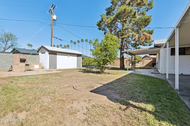 2740 N 21st Dr, Phoenix, AZ 85009 - view of yard with a fenced backyard, an outdoor structure, a patio, and a storage shed