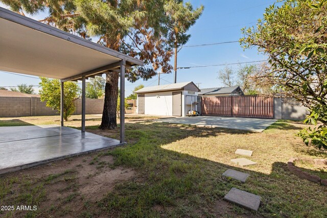 2740 N 21st Dr, Phoenix, AZ 85009 - view of yard with a patio area, an outbuilding, and a fenced backyard