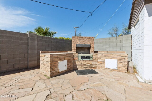 2740 N 21st Dr, Phoenix, AZ 85009 - view of patio / terrace featuring fence, area for grilling, and a fireplace