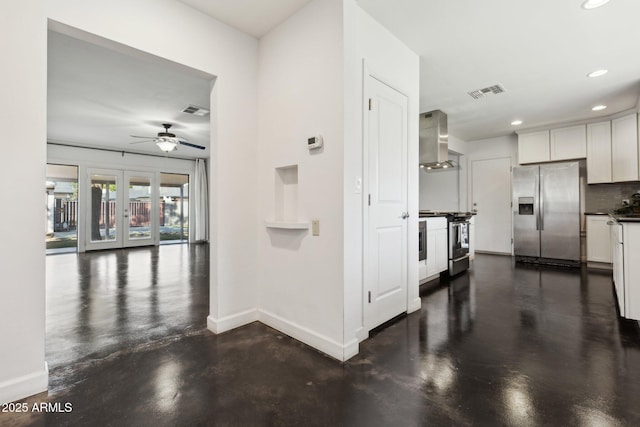 2740 N 21st Dr, Phoenix, AZ 85009 - interior space with wall chimney exhaust hood, finished concrete floors, a ceiling fan, stainless steel appliances, and baseboards