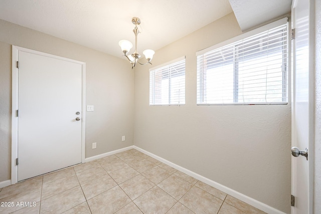 7439 E Ed Rice Ave, Mesa, AZ 85208 - empty room featuring a chandelier, light tile patterned flooring, and baseboards