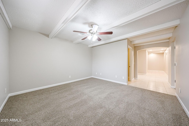 7439 E Ed Rice Ave, Mesa, AZ 85208 - carpeted empty room featuring a ceiling fan, arched walkways, a textured ceiling, baseboards, and tile patterned floors
