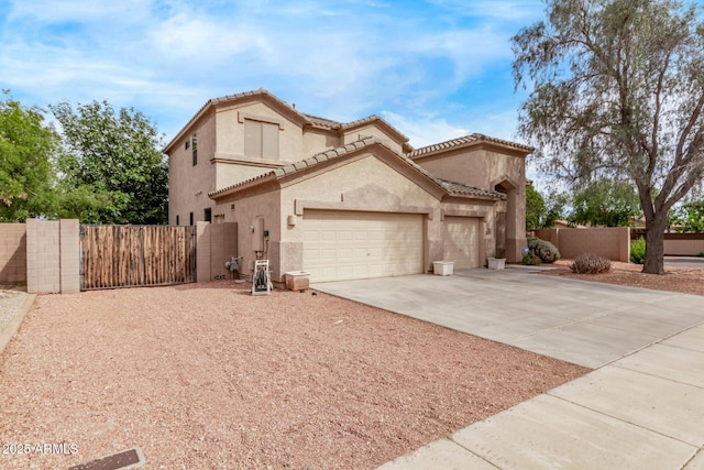 21373 N 94th Ave, Peoria, AZ 85382 - mediterranean / spanish house featuring a gate, a garage, fence, concrete driveway, and stucco siding