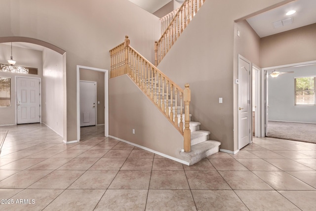 21373 N 94th Ave, Peoria, AZ 85382 - stairs featuring arched walkways, a high ceiling, and tile patterned floors