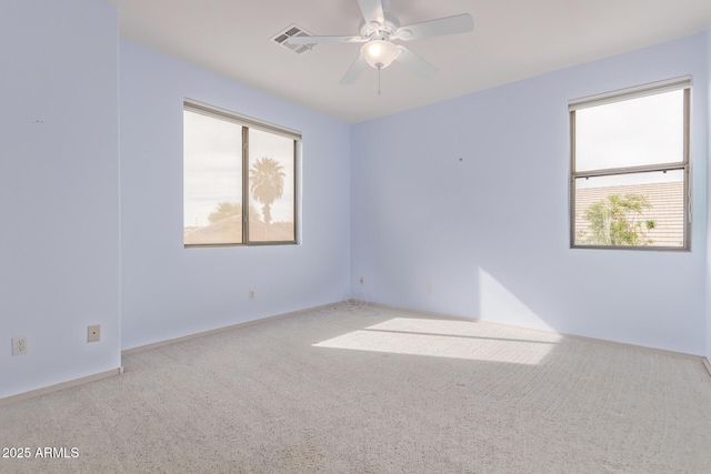 21373 N 94th Ave, Peoria, AZ 85382 - carpeted empty room with visible vents, baseboards, ceiling fan, and a healthy amount of sunlight