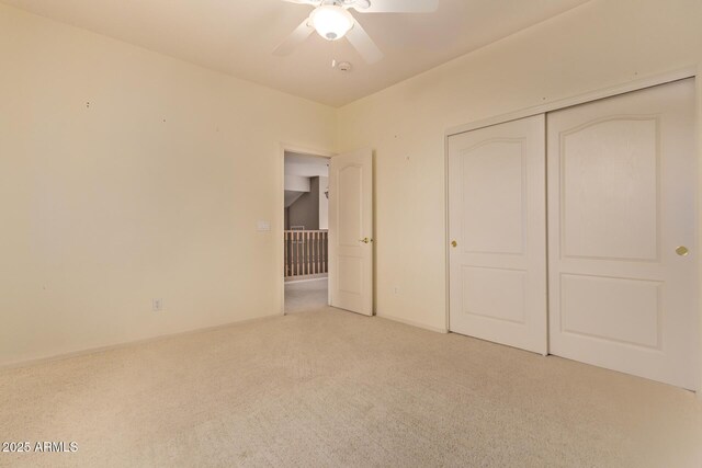 21373 N 94th Ave, Peoria, AZ 85382 - unfurnished bedroom featuring a ceiling fan, light carpet, and a closet