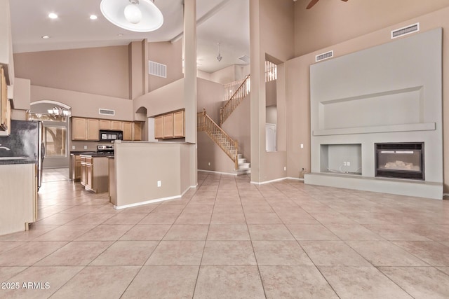 21373 N 94th Ave, Peoria, AZ 85382 - unfurnished living room featuring high vaulted ceiling, light tile patterned flooring, and visible vents