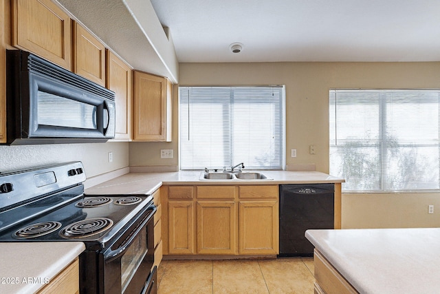 kitchen with black appliances, light tile patterned flooring, a sink, and light countertops