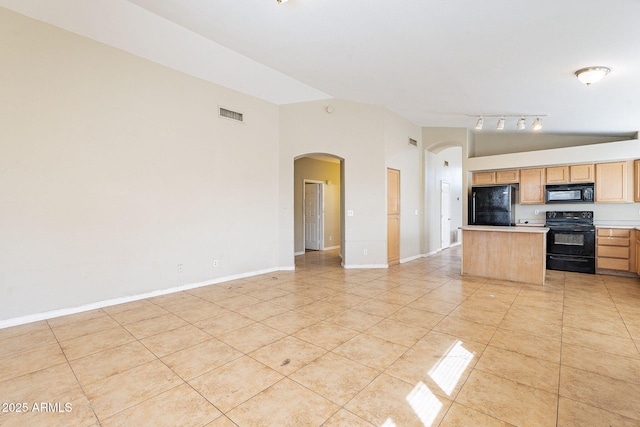 kitchen featuring arched walkways, light tile patterned flooring, visible vents, open floor plan, and black appliances