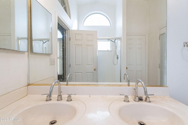 full bath with walk in shower, a sink, and double vanity