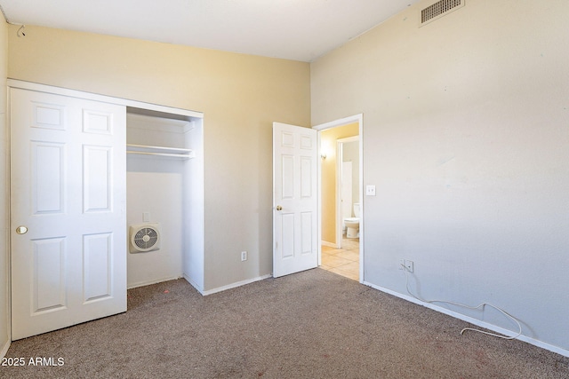 unfurnished bedroom featuring carpet floors, baseboards, visible vents, and a closet