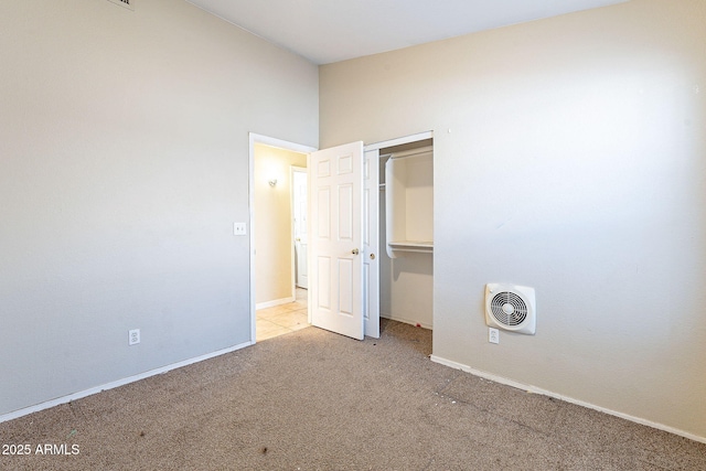 unfurnished bedroom featuring a closet, carpet flooring, visible vents, and baseboards