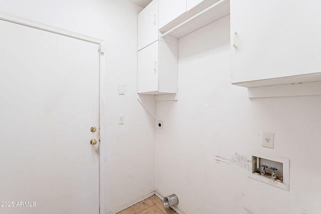 laundry area with light tile patterned floors, washer hookup, cabinet space, and electric dryer hookup