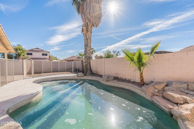 view of pool with a fenced backyard