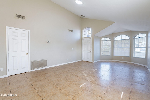 empty room featuring light tile patterned floors, visible vents, and baseboards