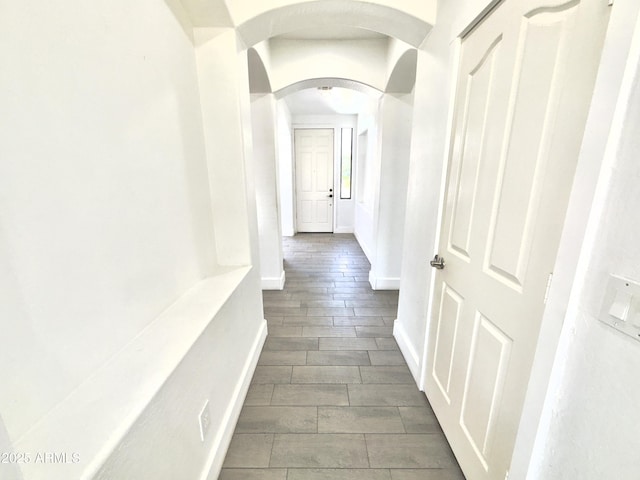 7116 W Sophie Ln, Laveen, AZ 85339 - hall with arched walkways, wood tiled floors, and baseboards