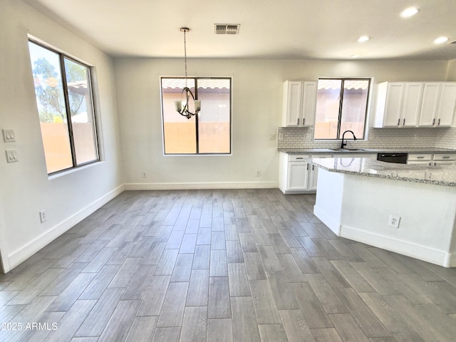 7116 W Sophie Ln, Laveen, AZ 85339 - kitchen featuring white cabinets, dark wood-style floors, light stone countertops, a sink, and dishwasher