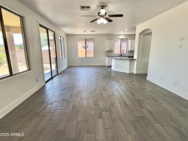 7116 W Sophie Ln, Laveen, AZ 85339 - unfurnished living room with a sink, dark wood-style floors, ceiling fan, baseboards, and recessed lighting