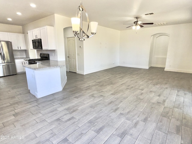 7116 W Sophie Ln, Laveen, AZ 85339 - kitchen featuring black appliances, a ceiling fan, light wood-style floors, white cabinets, and decorative backsplash