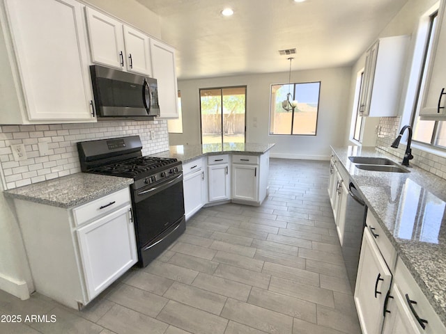 7116 W Sophie Ln, Laveen, AZ 85339 - kitchen featuring appliances with stainless steel finishes, a sink, a peninsula, white cabinets, and recessed lighting