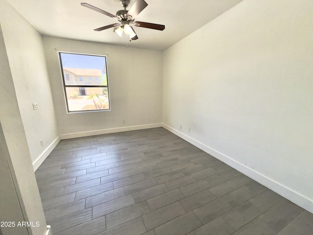 7116 W Sophie Ln, Laveen, AZ 85339 - empty room with ceiling fan, baseboards, and dark wood-style floors