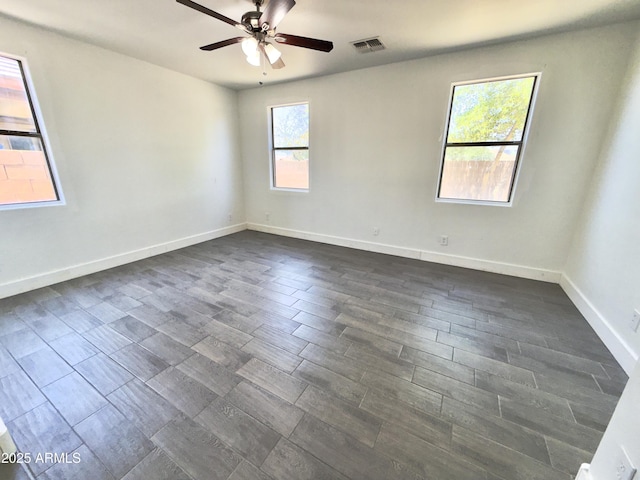 7116 W Sophie Ln, Laveen, AZ 85339 - spare room with a ceiling fan, dark wood-type flooring, and baseboards