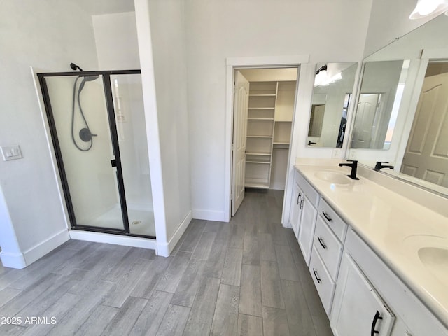 7116 W Sophie Ln, Laveen, AZ 85339 - full bath with baseboards, a stall shower, and wood finished floors