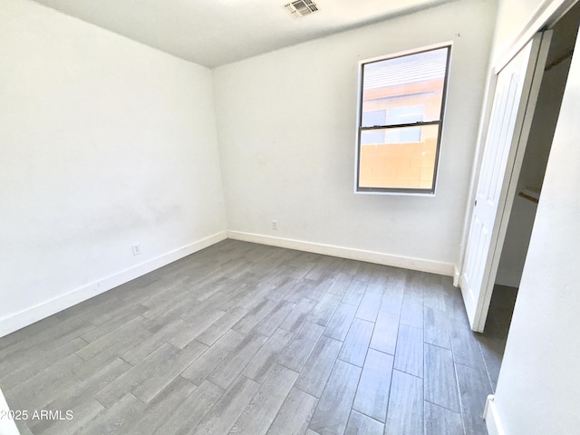 7116 W Sophie Ln, Laveen, AZ 85339 - unfurnished bedroom with wood finished floors and baseboards