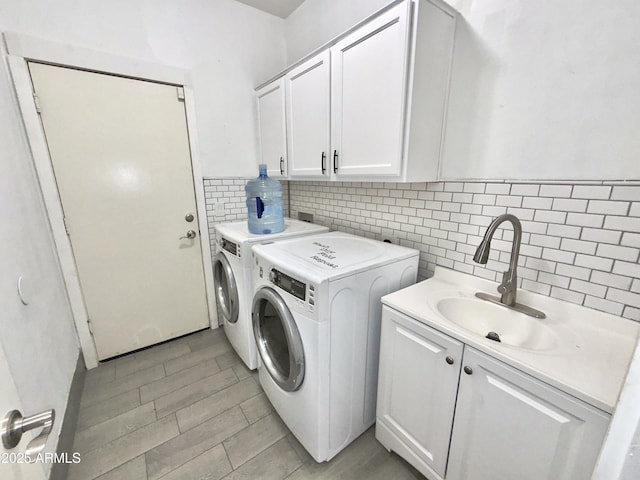 7116 W Sophie Ln, Laveen, AZ 85339 - washroom featuring washer and dryer, cabinet space, and light wood finished floors