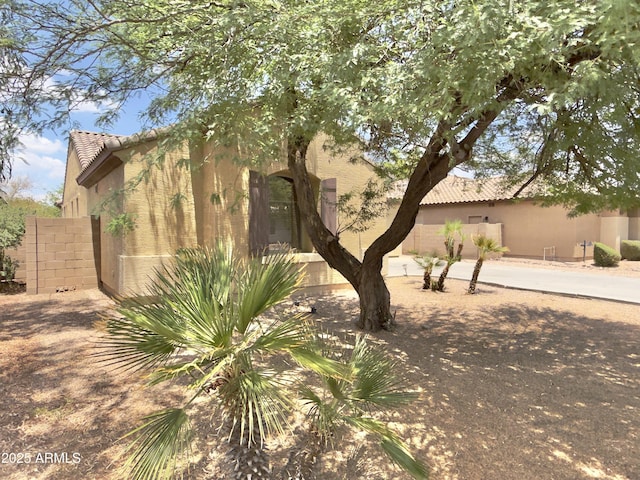 7116 W Sophie Ln, Laveen, AZ 85339 - view of property exterior with stucco siding and a tiled roof