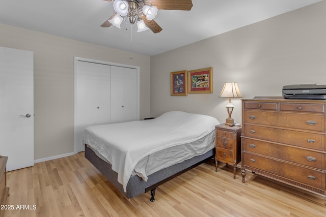 bedroom featuring baseboards, a closet, a ceiling fan, and light wood-style floors