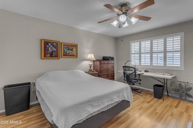 bedroom with wood finished floors and a ceiling fan