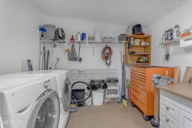 laundry room with washing machine and clothes dryer and cabinet space