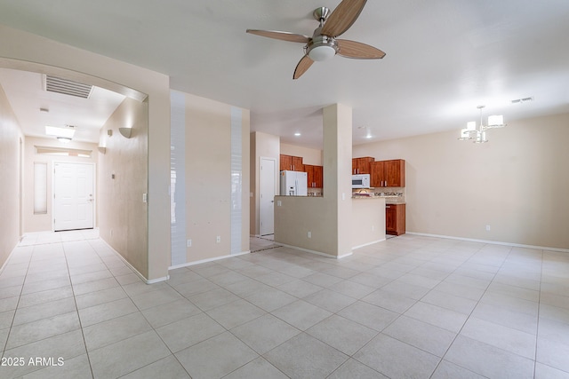 unfurnished living room with light tile patterned floors, baseboards, ceiling fan with notable chandelier, and visible vents