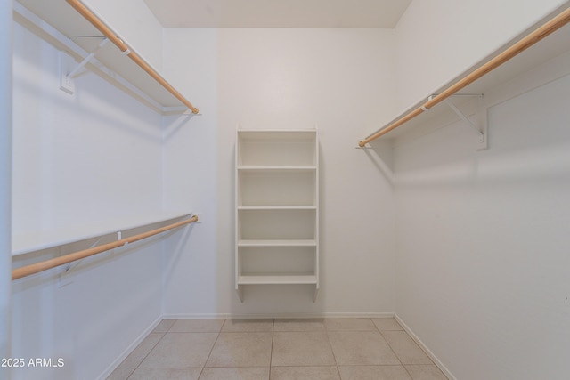 walk in closet with tile patterned floors